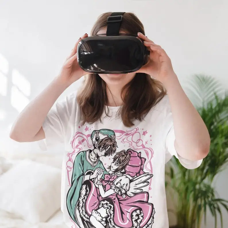 Here at Everythinganimee we only have the best shirts in the world! Step into the magical world of Cardcaptor Sakura with this enchanting Sakura & Shaoran Tee, capturing the sweet and iconic moment between two beloved characters. Designed for fans who cherish the heartwarming bond and whimsical style of the series,