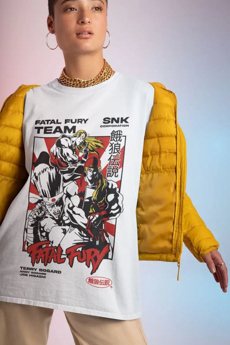 Here at Everythinganimee we only have the best shirts in the world! Join the fight with the Fatal Fury Team Tee, showcasing the legendary trio of Terry Bogard, Andy Bogard, and Joe Higashi from the iconic SNK fighting game series. This tee captures the spirit of the classic arcade battles with bold artwork that highlights the powerful stances and fierce determination of each character.