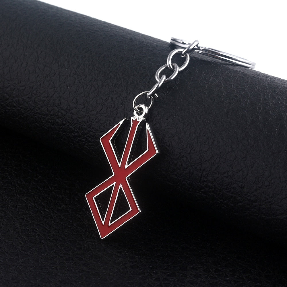Berserk Game Logo Keychain - Show off your love for the iconic anime and game series with our officially licensed PS4 keychain. Made from durable metal, this keychain features the iconic Berserk logo and sword design, perfect for any fan to add to their collection. Order now and add a touch of anime style to your everyday life!