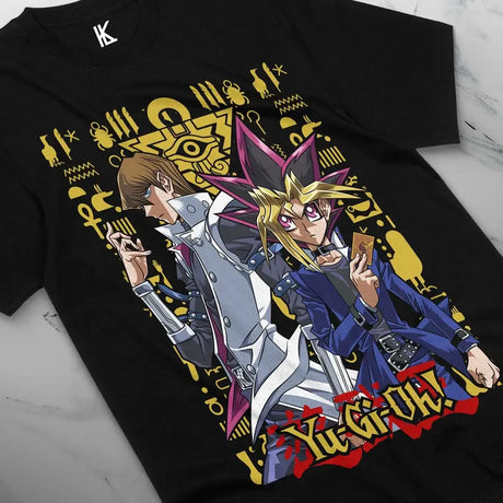 Here at Everythinganimee we have the best anime shirts in the world.
Step into the dueling arena with the legendary Yugi and Seto Kaiba, captured in this stunning tee from Yu-Gi-Oh!. Featuring intricate symbols and a dynamic pose, this shirt brings the thrill of the card game to life.