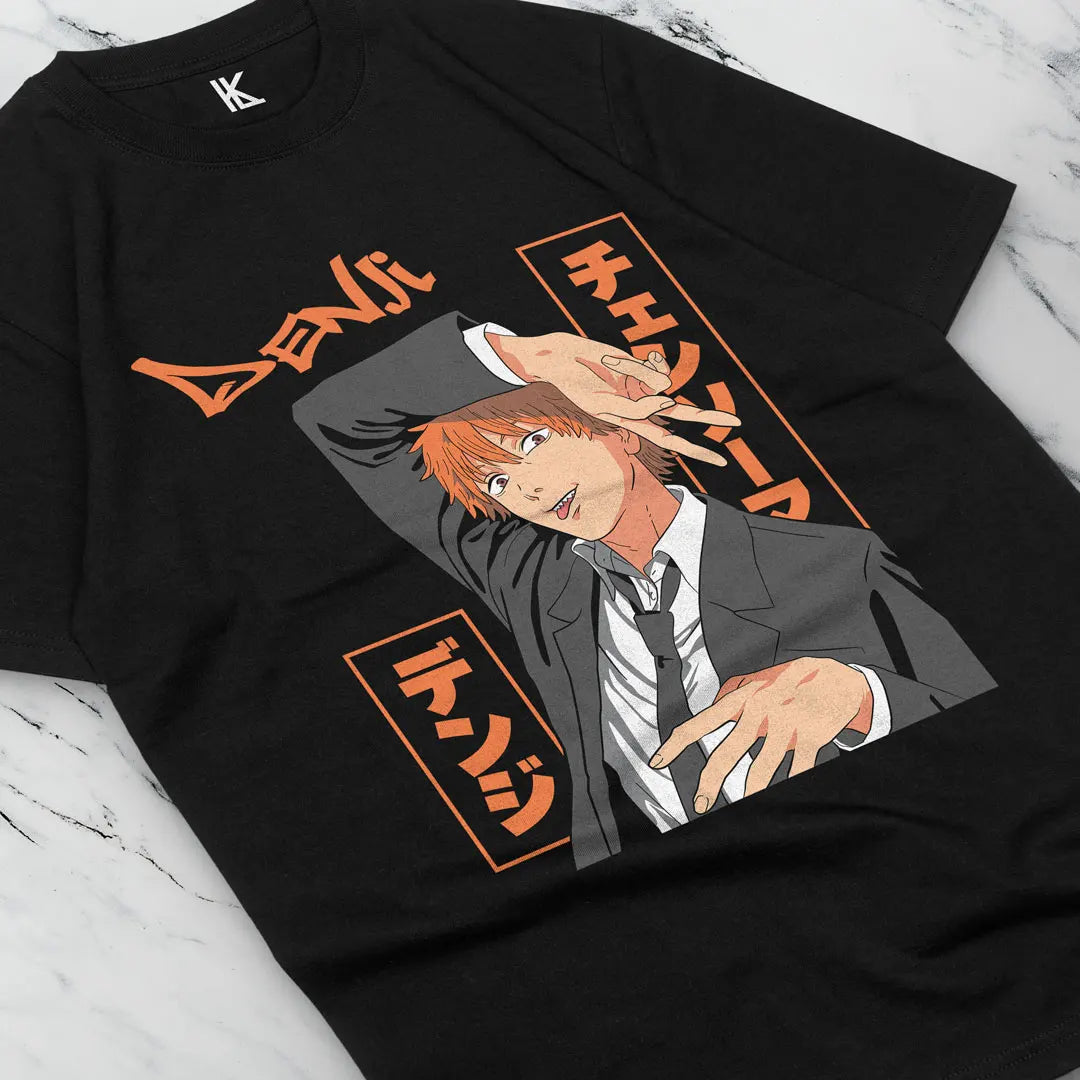 Here at Everythinganimee we have the best anime shirts in the world.
Unleash the power of Chainsaw Man with this striking Denji Tee, featuring the unpredictable and fearless Denji from the anime. The bold design captures Denji’s devil-may-care attitude.