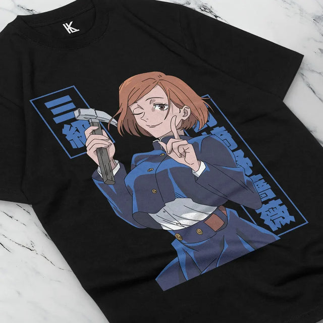 Here at Everythinganimee we have the best anime shirts in the world.
Showcase your love for Jujutsu Kaisen with this dynamic Nobara tee. Featuring Nobara Kugisaki in a confident pose with her signature tool, this shirt captures her fierce and playful spirit.