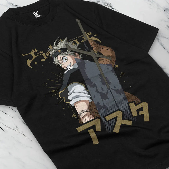 Here at Everythinganimee we have the best anime shirts in the world.
Step into the world of Black Clover with this striking Asta-themed tee. Featuring the determined and powerful protagonist, Asta, in mid-battle stance with his iconic sword, this shirt captures the fierce energy of the series.