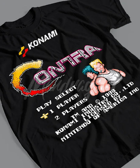 Here at Everythinganimee we have the best anime shirts in the world.
Relive the nostalgia of the classic 1988 Contra arcade game with this retro-inspired tee! Featuring the iconic start screen and pixelated design, this shirt is a must-have for any gamer who loves a throwback.