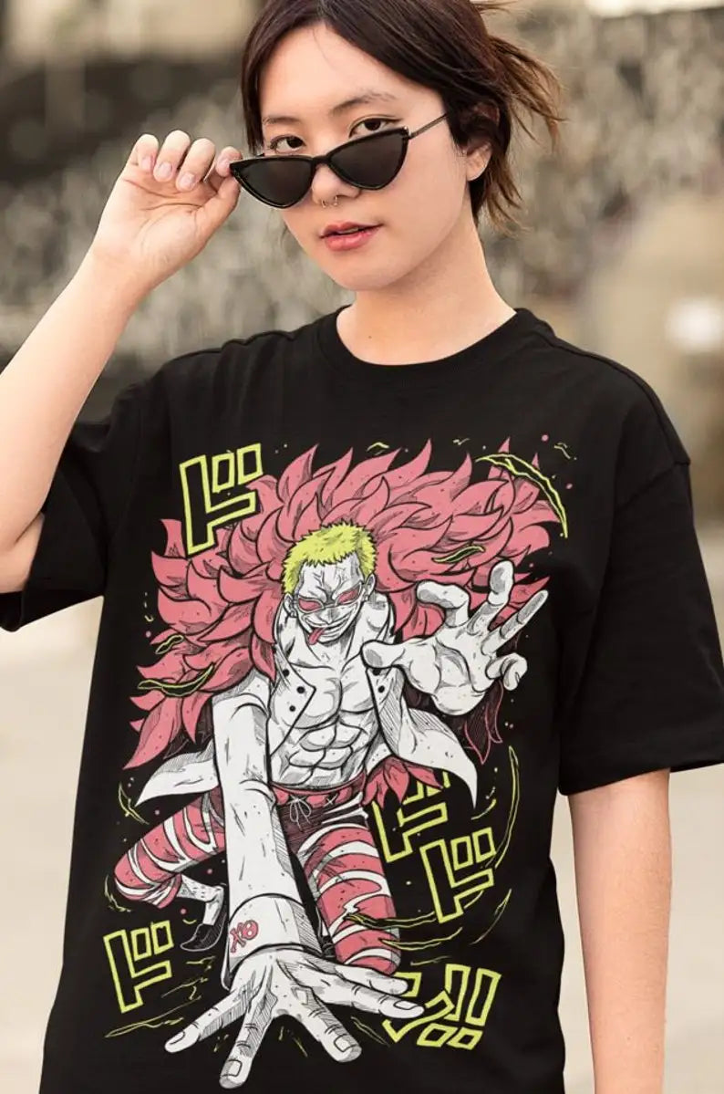 This tee features a striking print of  Doflamingo , capturing an intense aura of the fan-favorite character.  If you are looking for more One Piece Merch, We have it all! | Check out all our Anime Merch now!